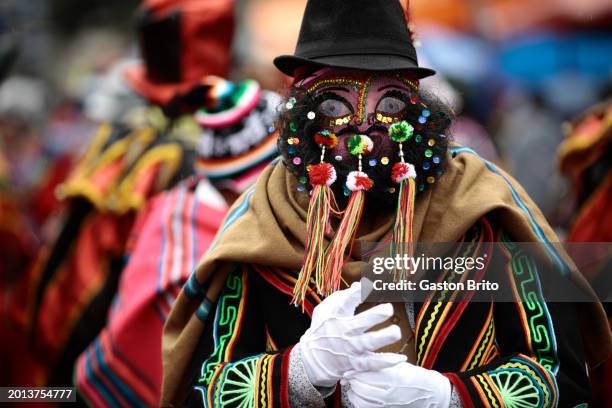 Man wearing a mask of Chuta Cholero dances during the iconic parade of 'Entierro del Pepino' at General Cemetery of La Paz on February 18, 2024 in La...