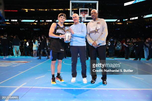 John T. Stankey presents the AT&T Slam Dunk trophy to Mac McClung with Julius Erving as a part of State Farm All-Star Saturday Night on Saturday,...