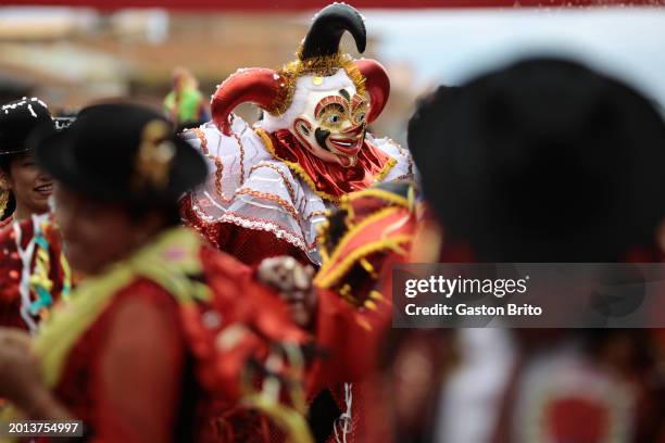 Man wearing a mask during the iconic parade of 'Entierro del Pepino' at General Cemetery of La Paz on February 18, 2024 in La Paz, Bolivia. The...