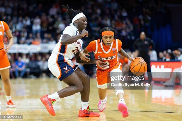 Dyaisha Fair of the Syracuse Orange drives past Alexia Smith of the Virginia Cavaliers in the first half during a game at John Paul Jones Arena on...