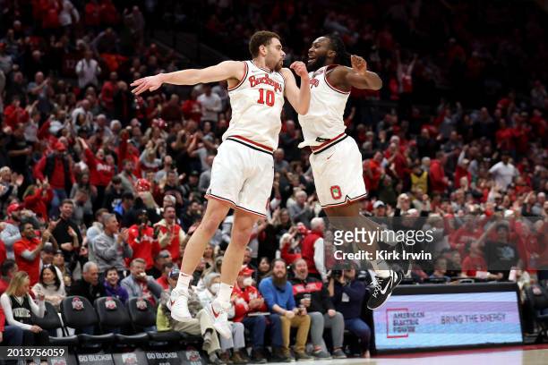 Jamison Battle of the Ohio State Buckeyes is congratulated by Bruce Thornton after making a three point shot during the second half of the game...