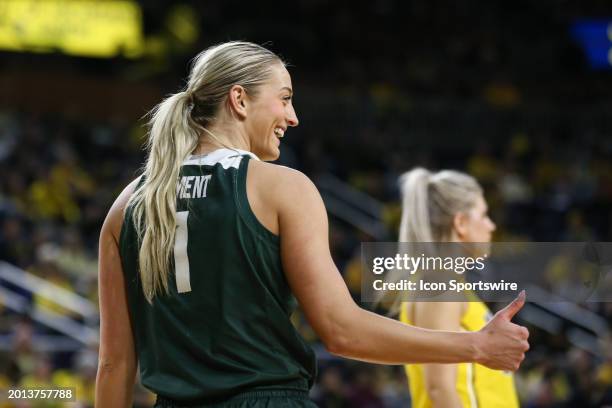 Michigan State Spartans guard Tory Ozment gives a thumbs up gesture to her teammates on the bench during the third quarter of a regular season Big...