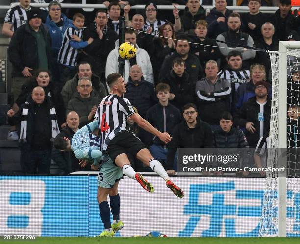 Newcastle United's Sven Botman heads the ball wide of the goal under pressure from Bournemouth's Adam Smith during the Premier League match between...