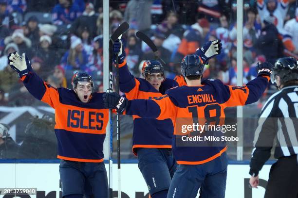 Anders Lee of the New York Islanders is congratulated by Pierre Engvall and Jean-Gabriel Pageau during the 2024 Navy Federal Credit Union Stadium...