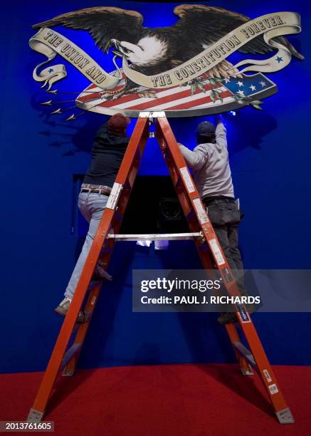 Stage hand workers adjust the Commission on Presidential Debates logo on October 6, 2008 inside the Curb Event Center at Belmont University in...