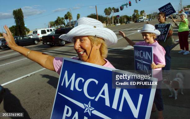 Carole Holland with Irene Grogan show passing motorists their support for US Republican presidential candidate John McCain and his running mate Sarah...