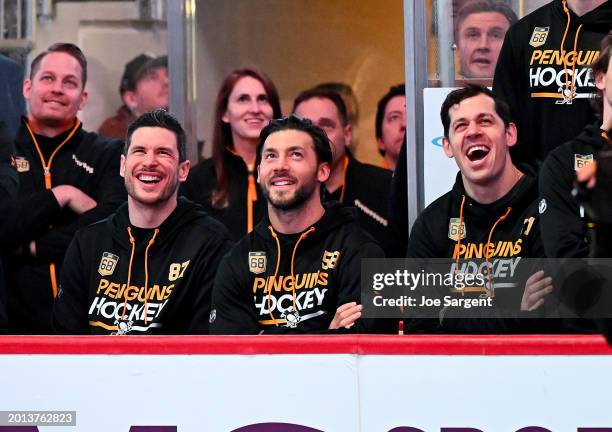 Sidney Crosby, Kris Letang and Evgeni Malkin of the Pittsburgh Penguins watch Jaromir Jagr's jersey retirement ceremony before the game against the...