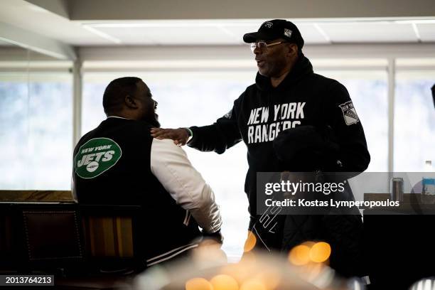 Carl Banks and Damien Woody have a chat in the suite during the game between the New York Rangers and the New York Islanders at MetLife Stadium on...