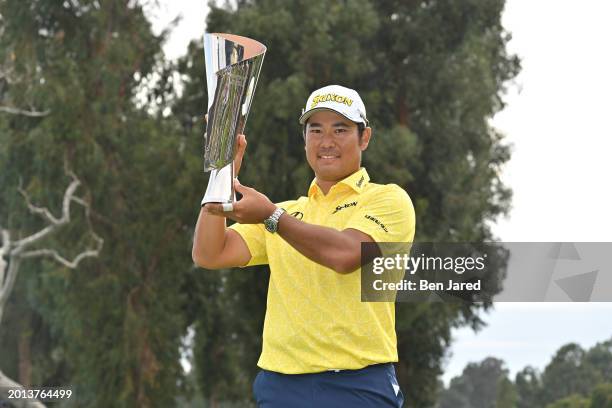 Hideki Matsuyama of Japan holds the trophy on the 18th green after the final round of The Genesis Invitational at Riviera Country Club on February...