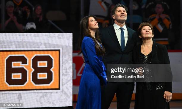 Jaromir Jagr, along with his mother Anna Jagrova and girlfriend Dominika Branisova look up at the videoboard during his jersey retirement ceremony...