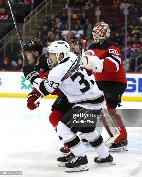 Viktor Arvidsson of the Los Angeles Kings fights for position as Kevin Bahl and Nico Daws of New Jersey Devils defend during the first period at...