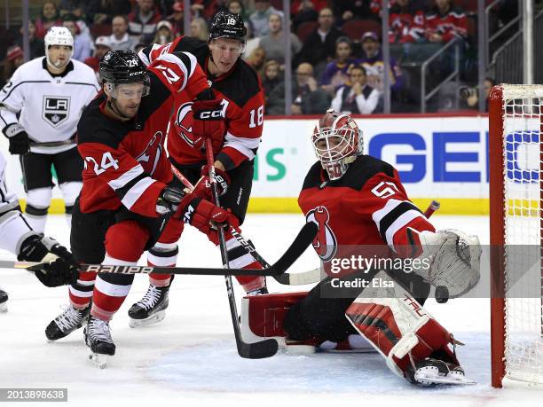 Nico Daws of the New Jersey Devils stops a shot as teammate Colin Miller of the New Jersey Devils looks on during the first period against the Los...