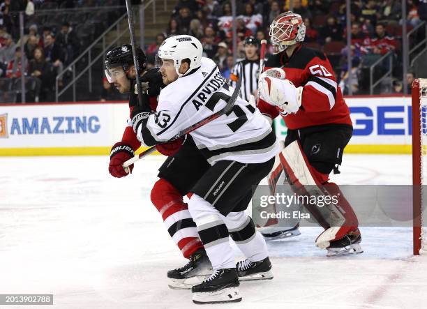 Viktor Arvidsson of the Los Angeles Kings and Kevin Bahl of the New Jersey Devils fight for position during the first period at Prudential Center on...