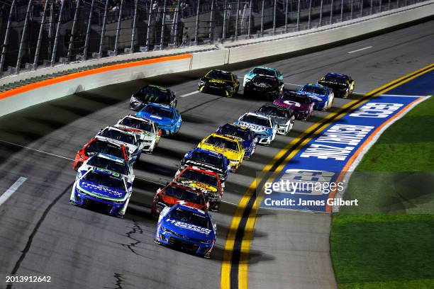 Kyle Larson, driver of the HendrickCars.com Chevrolet, and Daniel Suarez, driver of the Freeway Insurance Chevrolet, lead the field during the NASCAR...