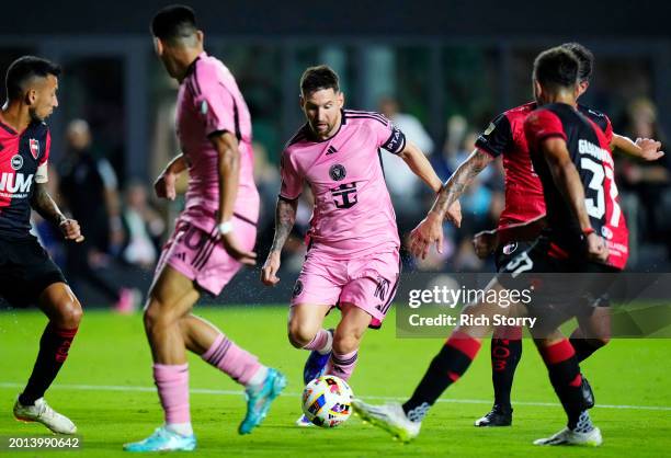 Lionel Messi of Inter Miami CF dribbles the ball during the first half of a friendly match against Newell's Old Boys at DRV PNK Stadium on February...