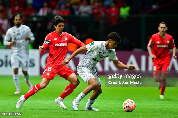 Carlos Orrantia of Toluca pressures Andy Rojas of Herediano for the ball during the second leg of the CONCACAF Champions League game between Toluca...