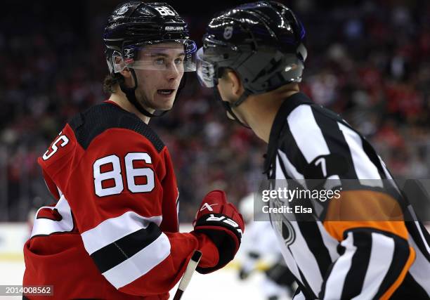 Jack Hughes of the New Jersey Devils argues a non call with referee Garrett Rank during the second period against the Los Angeles Kings at Prudential...