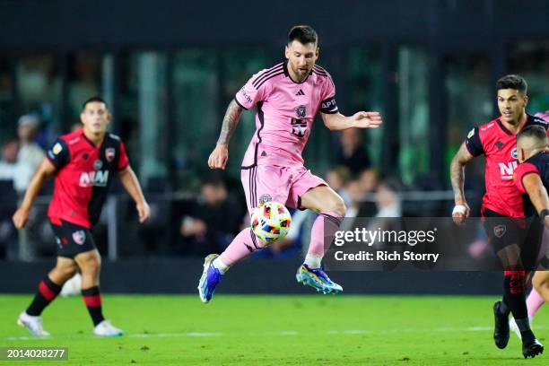 Lionel Messi of Inter Miami CF handles the ball during the second half of a friendly match against Newell's Old Boys at DRV PNK Stadium on February...