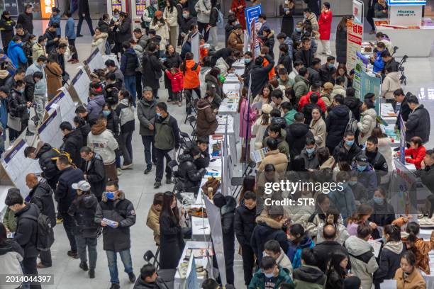 People attend a job fair in Zhengzhou, in central China's Henan province on February 19, 2024. / China OUT