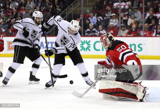 Quinton Byfield of the Los Angeles Kings heads for the net as Nico Daws of the New Jersey Devils defends during the third period at Prudential Center...