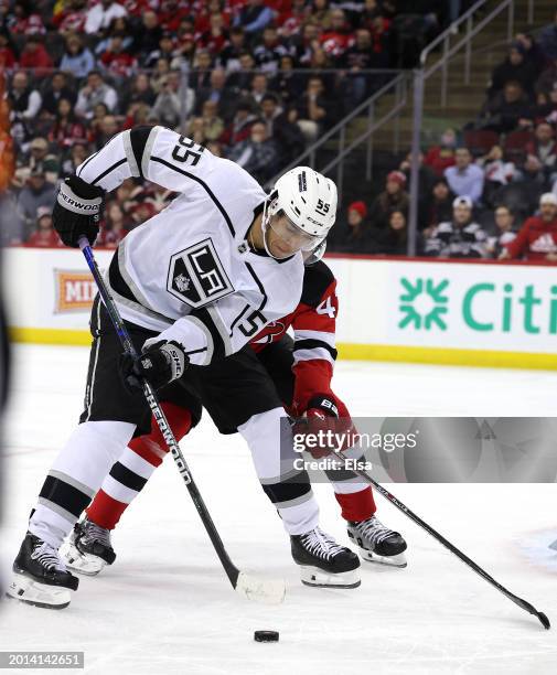 Quinton Byfield of the Los Angeles Kings heads for the net as Luke Hughes of the New Jersey Devils defends during the third period at Prudential...