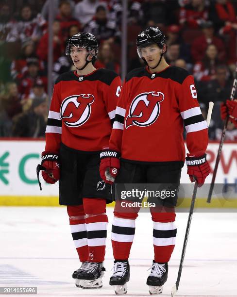 Luke Hughes and John Marino of the New Jersey Devils react during the third period against the Los Angeles Kings at Prudential Center on February 15,...