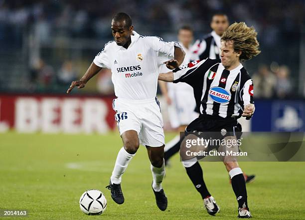 Flavio Conceicao of Real Madrid is tackled by Pavel Nedved of Juventus during the UEFA Champions League semi final, second leg match between Juventus...