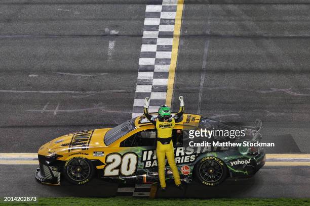 Christopher Bell, driver of the DEWALT/Interstate Batteries Toyota, celebrates after winning the NASCAR Cup Series Bluegreen Vacations Duel at...