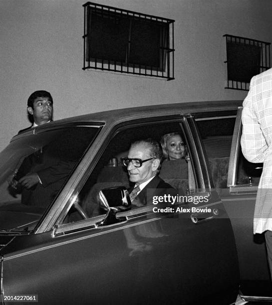 Mohammad Reza Pahlavi Former Shah of Iran with wife Farah Pahlavi arrive in front of a restaurant in Cuernavaca, 26th June 1979. Following the...