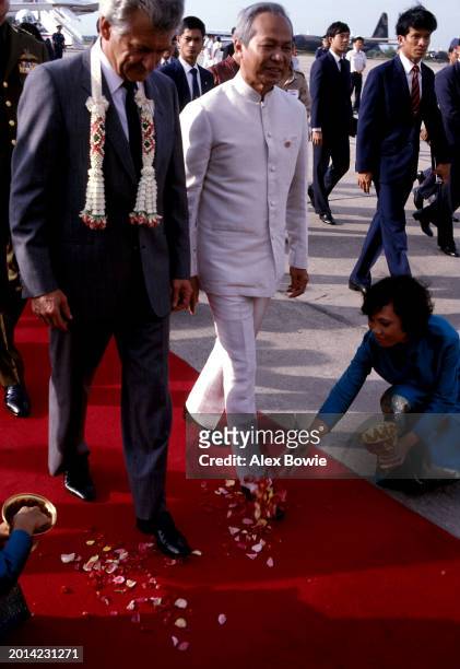 Flower petals are strewn at the feet of Australian Prime Minister Bob Hawke and Prime Minister of Thailand General Prem Tinsulanonda in a traditional...