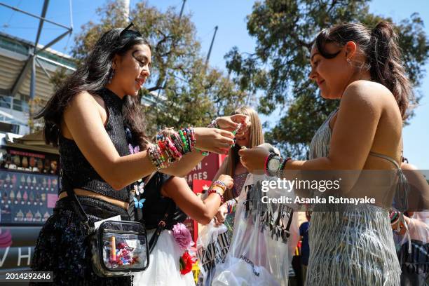 Taylor Swift fans also known as "Swifties" exchange friendship bracelets worn on their wrists as they arrive before Swift performs as part of her...
