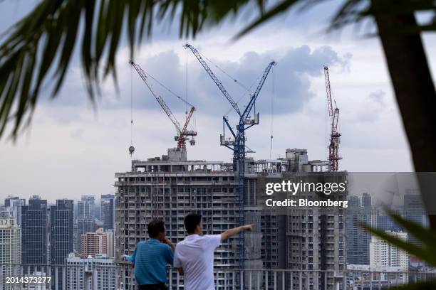 Buildings under construction in Singapore, on Saturday, Feb. 17, 2024. Singapore expects its budget to swing back to a surplus in the fiscal year...