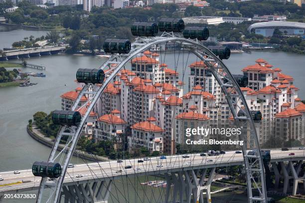 The Singapore Flyer and residential buildings in Singapore, on Saturday, Feb. 17, 2024. Singapore expects its budget to swing back to a surplus in...