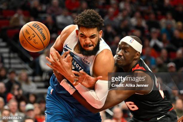 Karl-Anthony Towns of the Minnesota Timberwolves and Duop Reath of the Portland Trail Blazers battle for the ball during the third quarter at the...
