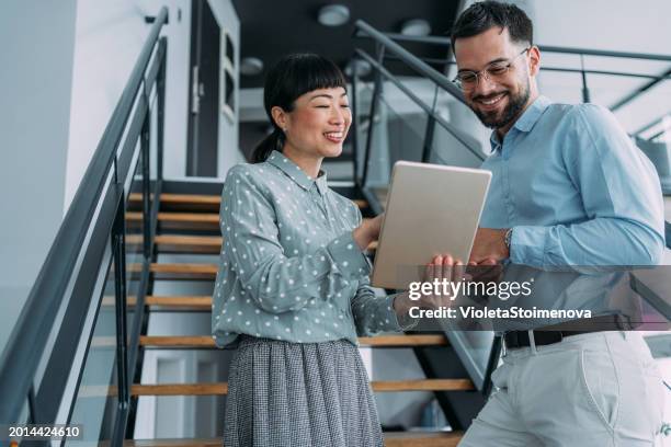 business colleagues talking on stairs in the office. - reklam bildbanksfoton och bilder