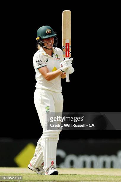 Annabel Sutherland of Australia raises her bat after scoring 150runs during day two of the Women's Test match between Australia and South Africa at...