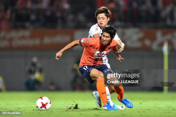 Shigeru Yokotani of Omiya Ardija controls the ball against Ko Matsubara of Shimizu S-Pulse during the J.League J1 match between Omiya Ardija and...