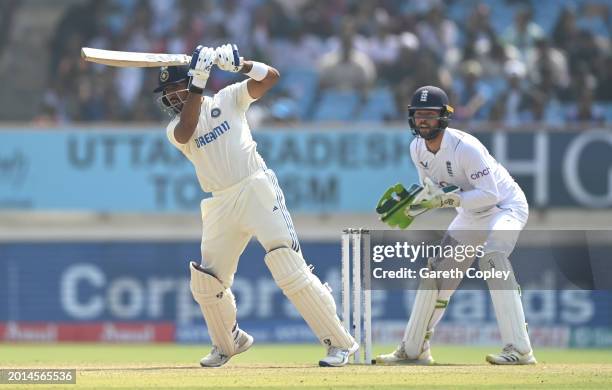 India batsman Dhruv Jurel hits out watched by wicketkeeper Ben Foakes during day two of the 3rd Test Match between India and England at Saurashtra...