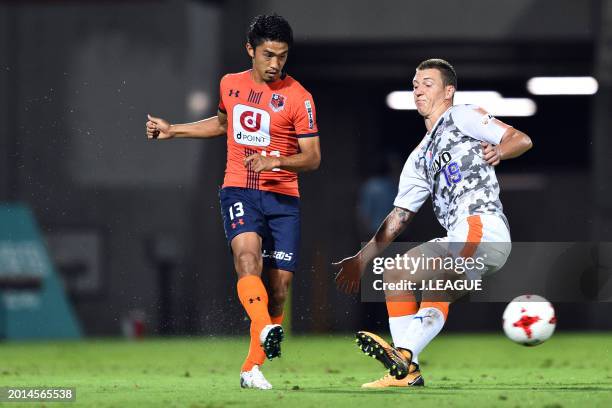 Daisuke Watabe of Omiya Ardija controls the ball against Mitchell Duke of Shimizu S-Pulse during the J.League J1 match between Omiya Ardija and...