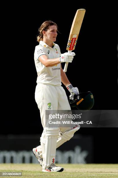 Annabel Sutherland of Australia raises her bat after scoring 200 runs during day two of the Women's Test match between Australia and South Africa at...