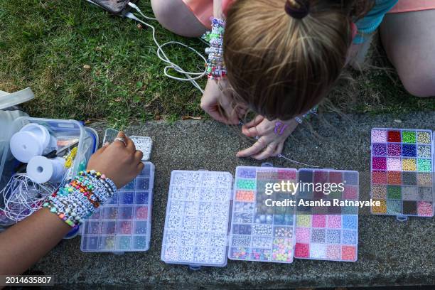 Taylor Swift fans, also known as "Swifties", make friendship bracelets at Melbourne Cricket Ground on February 16, 2024 in Melbourne, Australia....