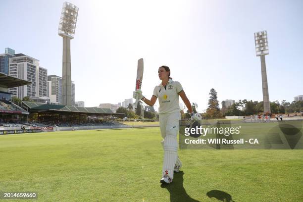 Annabel Sutherland of Australia raises her bat as she leaves the field after scoring 210 runs during day two of the Women's Test match between...