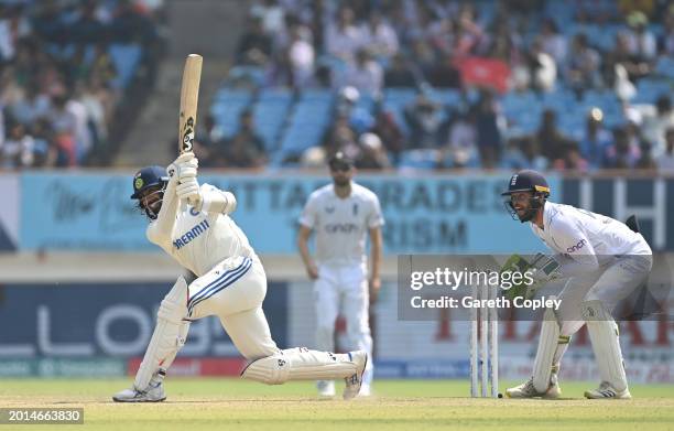 India batsman Jasprit Bumrah hits a six watched by Ben Foakes during day two of the 3rd Test Match between India and England at Saurashtra Cricket...