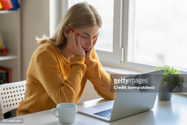 stressed woman while working on laptop - wasting time and money stock pictures, royalty-free photos & images