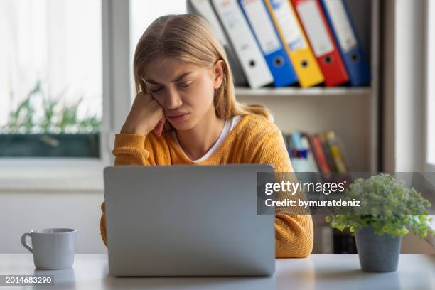 stressed woman while working on laptop - wasting time and money stock pictures, royalty-free photos & images