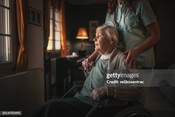 nurse in a home visit to an elderly woman with disabilities - social services stock pictures, royalty-free photos & images