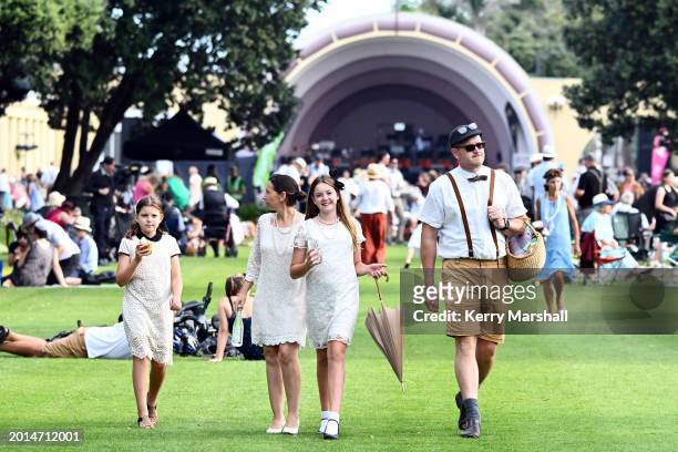 Family in Art Deco costume enjoys the evening on February 16, 2024 in Napier, New Zealand. The City of Napier celebrated the first official Art Deco...
