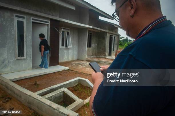 Andi Cristop Simanjuntak, a 50-year-old member of the Indonesian Photojournalist of Medan, and his wife, Jihan Astri Lubis are showing their...