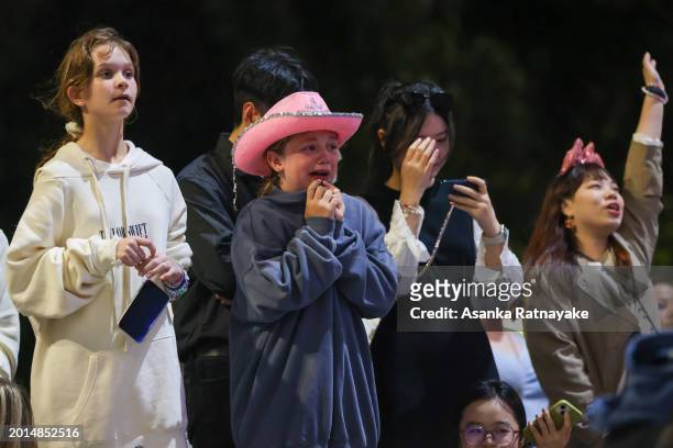 Taylor Swift fans, also known as "Swifties" with no tickets sing and dance during the concert outside the Melbourne Cricket Ground on February 16,...