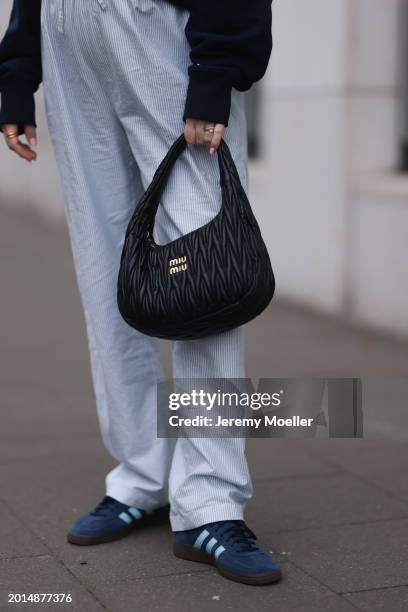 Victoria Thomas seen wearing Hernameis navy blue oversized cotton logo pattern hooded sweater, Hernameis white / blue striped long pants, Miu Miu...